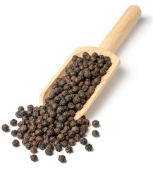 whole black peppercorns in the wooden scoop, isolated on white