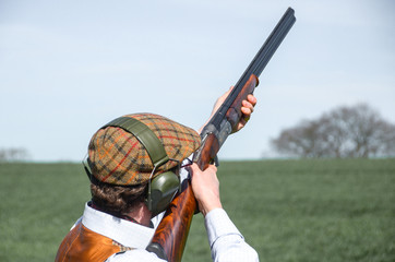 A man with shotgun clay pigeon shooting