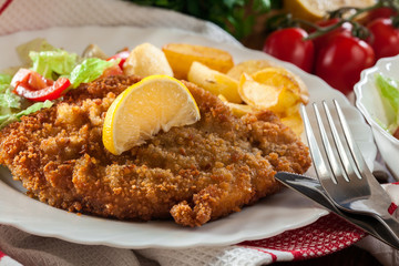 Breaded viennese schnitzel with baked potatoes
