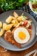 Breaded viennese schnitzel with fried agg