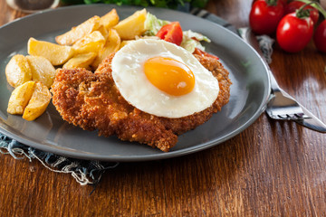 Breaded viennese schnitzel with fried agg