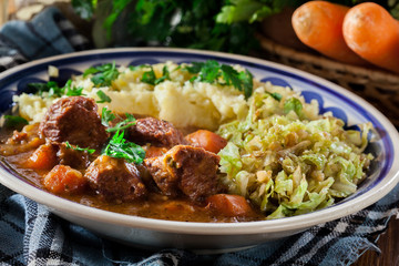 Traditional irish stew served with potatoes and cabbage