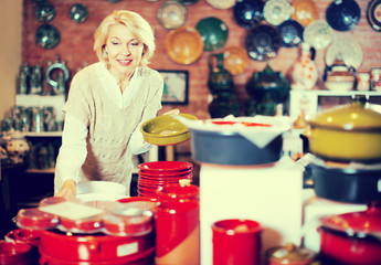 Woman posing with ceramic tableware