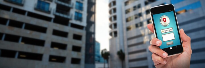 Composite image of cropped hand of person holding mobile phone