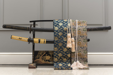 Two traditional Japanese samurai swords katana on a stand.