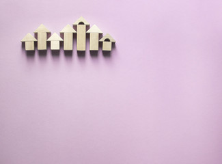 on a pink background houses of wooden cubes 