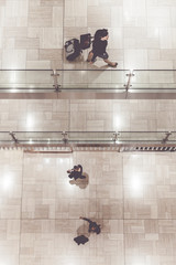 people walking on different levels of a mall