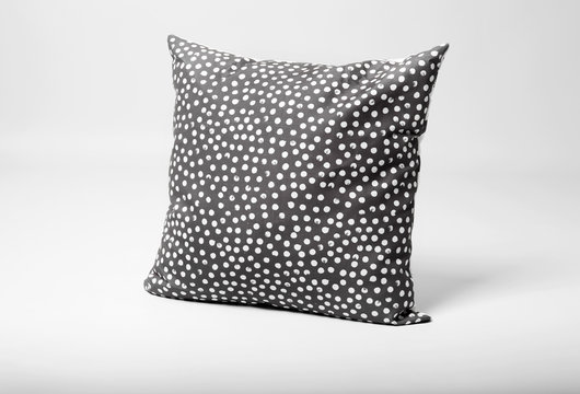 Soft decorative pillow on light background