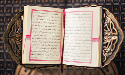 Open holy book of Muslims on stand