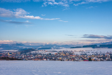 Fototapeta premium Snowy winter landscape with Rosina village near Zilina town, Slovakia, Europe.