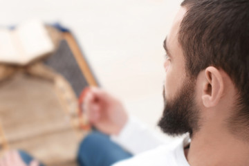 Young Muslim man praying, closeup