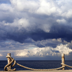 Fototapeta na wymiar Seafront, sea and cloudy sky before storm