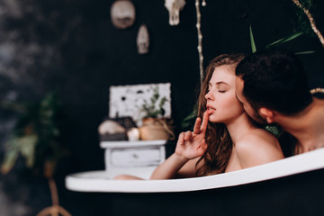 The loving pleasures of a young married couple in the bathroom.