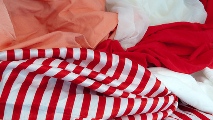 Red white and pink colored crinceld fabric with lines 