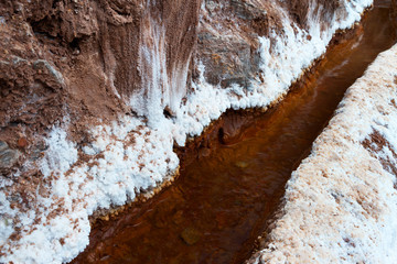 Salinas de Maras in southern Peru, a view of drainage that distributes water between salt ponds with salt crust around 