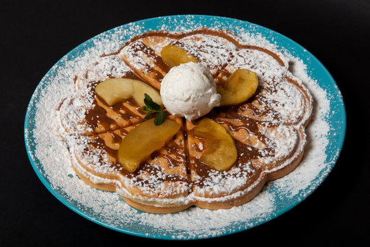 Chopped caramelized apples for breakfast on a black background