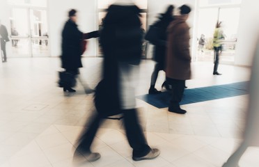 abstract crowd of anonymous blurred people walking in a shopping mall