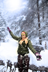 Happy young girl in snowy forest