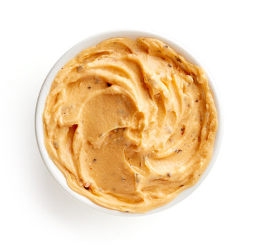 Bowl of paprika butter isolated on white, from above