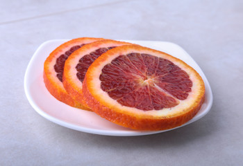 Fototapeta na wymiar Orange fruit. Orange and lemon slice on white plate. Top view.