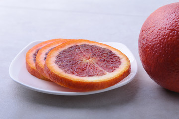 Orange fruit. Orange and lemon slice on white plate. Top view.