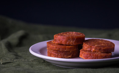 Stacked pepperoni on a snack plate