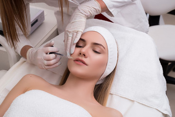 Save your youth! Beautiful young woman getting cosmetic treatmen