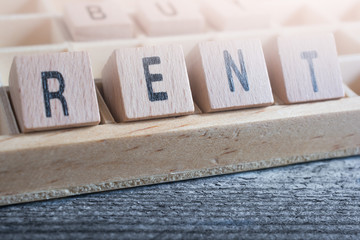 Closeup Of The Word Rent Formed By Wooden Blocks In A Type Case