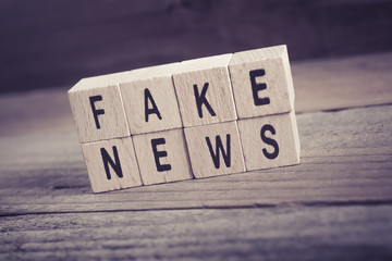 Macro Of The Words Fake News Formed By Wooden Blocks On A Wooden Floor