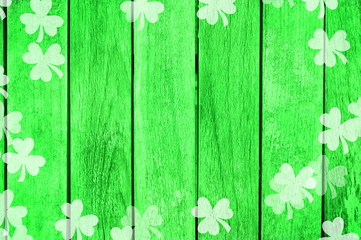 Green wooden background with clover shapes