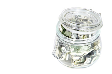 dollars in a glass piggy bank
