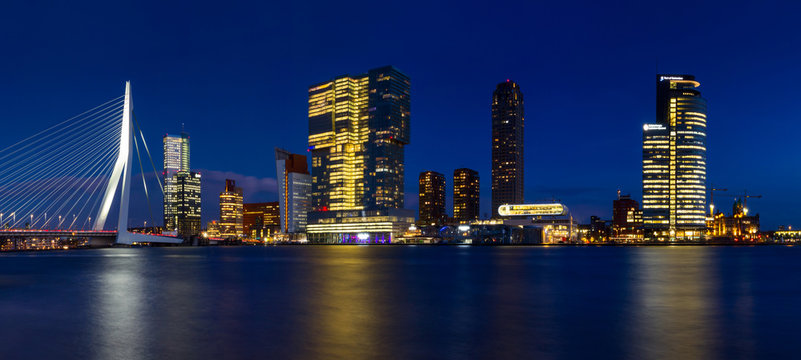 City Landscape, panorama - Night view on Erasmus Bridge and district Feijenoord city of Rotterdam, The Netherlands.