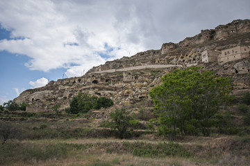 Fototapeta na wymiar Old stone houses, caves and badlands in Cappadocia