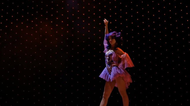 Beautiful girl with blue hair in light of spotlight