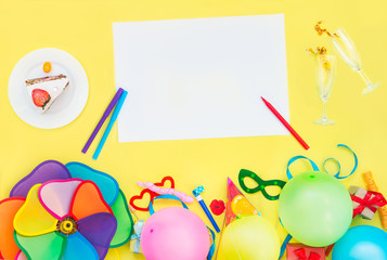 Obraz premium Bright yellow background with festive cake, empty blank and champagne glasses with confetti ribbons, party tools and decoration. Happy birthday design concept. Place for text. Top view.