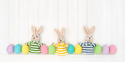 Easter decoration eggs funny bunnies wooden background