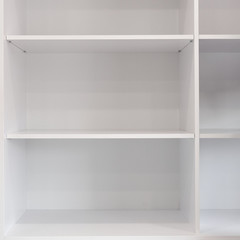 Closeup of empty white wooden bookshelf in modern room