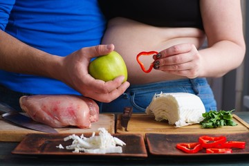 Overweight couple cooking diet food. Fat man and woman preparing low-calorie meals. Weight losing,...