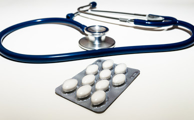 Pills and Stethoscope with soft shadow, on the background. Shallow DOF with selective focus on the front.