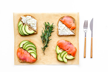 Mini sandwich set with french baguette, cheese, fish and avocado on white background top view