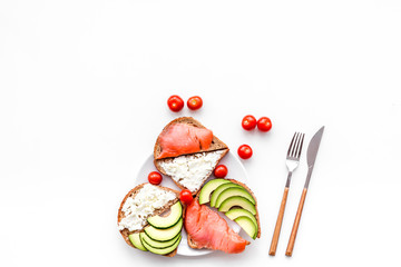 Mini sandwich set with french baguette, cheese, fish and avocado on white background top view mock up