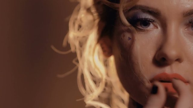 Beautiful sensual blonde touches her face