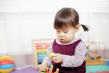 baby girl play toy blocks at home