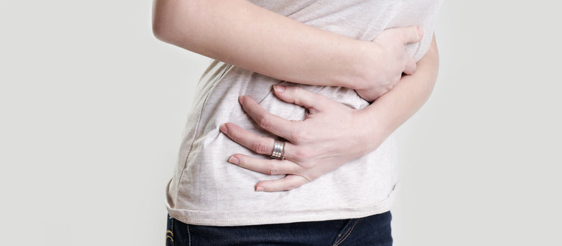 Woman having painful stomachache, chronic gastritis or abdomen bloating 