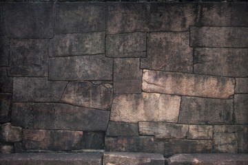 Old stone bricklaying with flat lines of seams and the processed stones of irregular shape accurately and densely adjusted to each other.