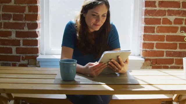Slow motion of woman sitting with laptop and then becomes worried