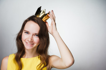 beautiful happy young girl in yellow dress, on head wearing golden crown, smiling, celebrating...