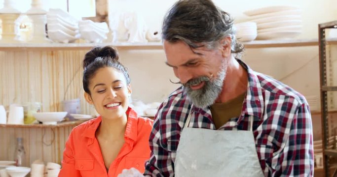 Male and female potter working together 