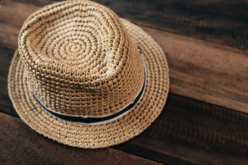 Fototapeta na wymiar straw hat on a wooden table with copy space.