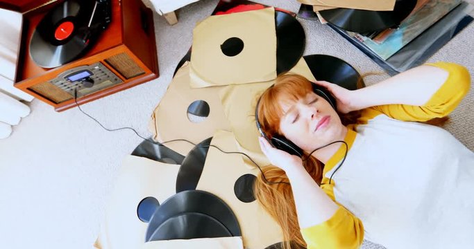 Happy woman listening music on headphones